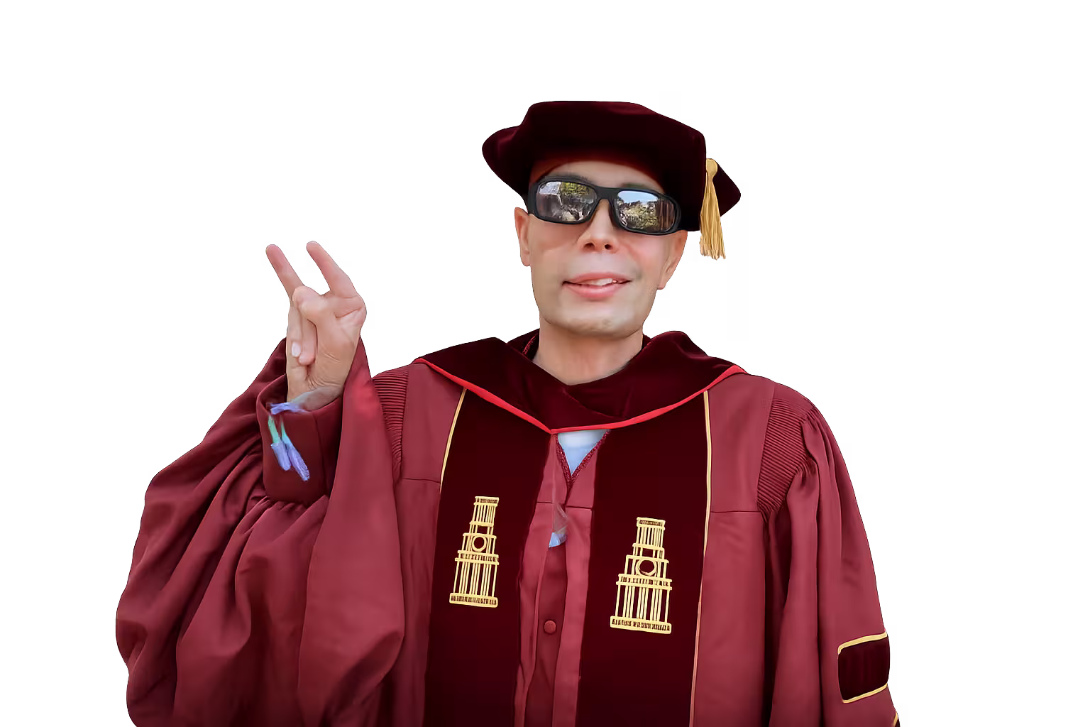 Dr. Qusay in doctoral cap and gown giving the Longhorn hand sign — Hook 'em — at his UT Austin Ph.D. graduation